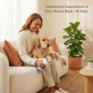 A happy pet owner using the PawClean Pro automatic paw washer on a calm dog in a bright, modern living room.